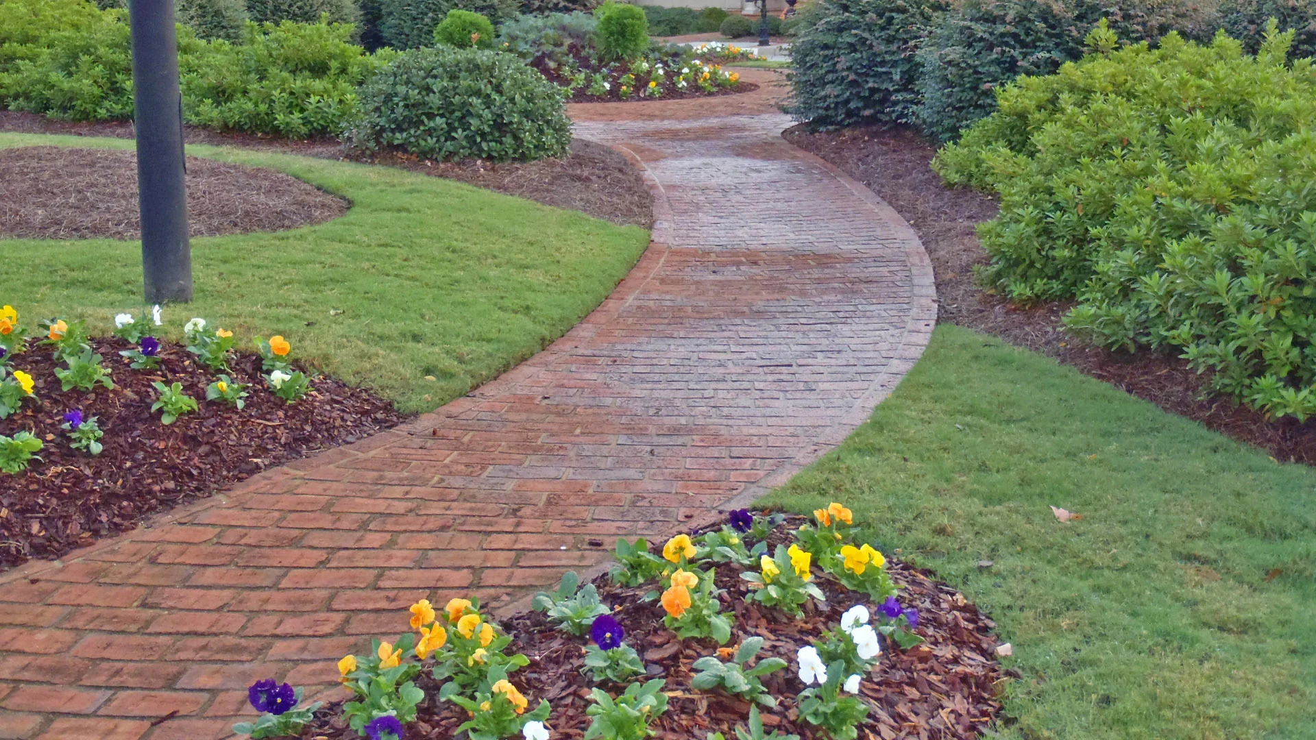 Landscaping with annuals and a paver walkway installation.
