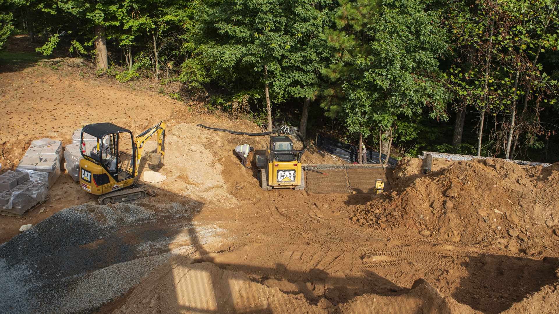 Our team grading a property, preparing for a new retaining wall, fire pit, and patio.