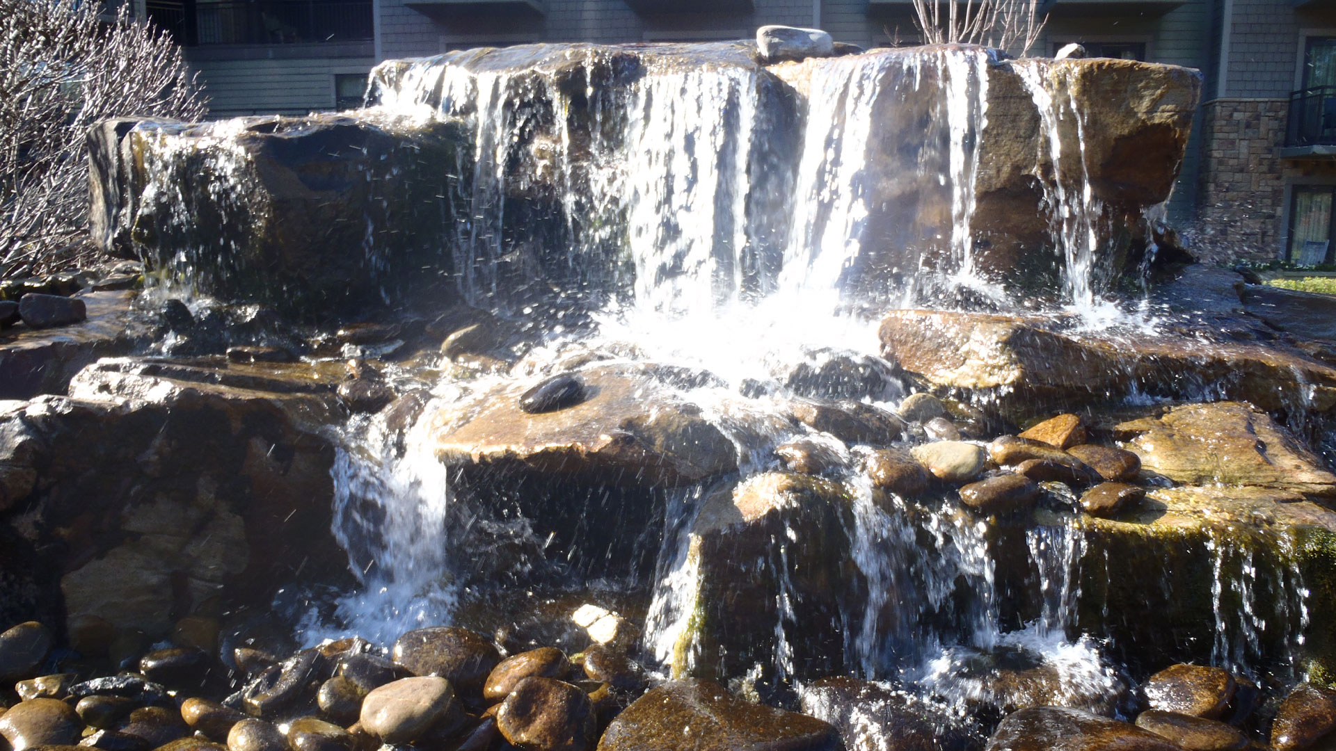 Water fall feature in a landscaping bed at a home in Atlanta, GA.