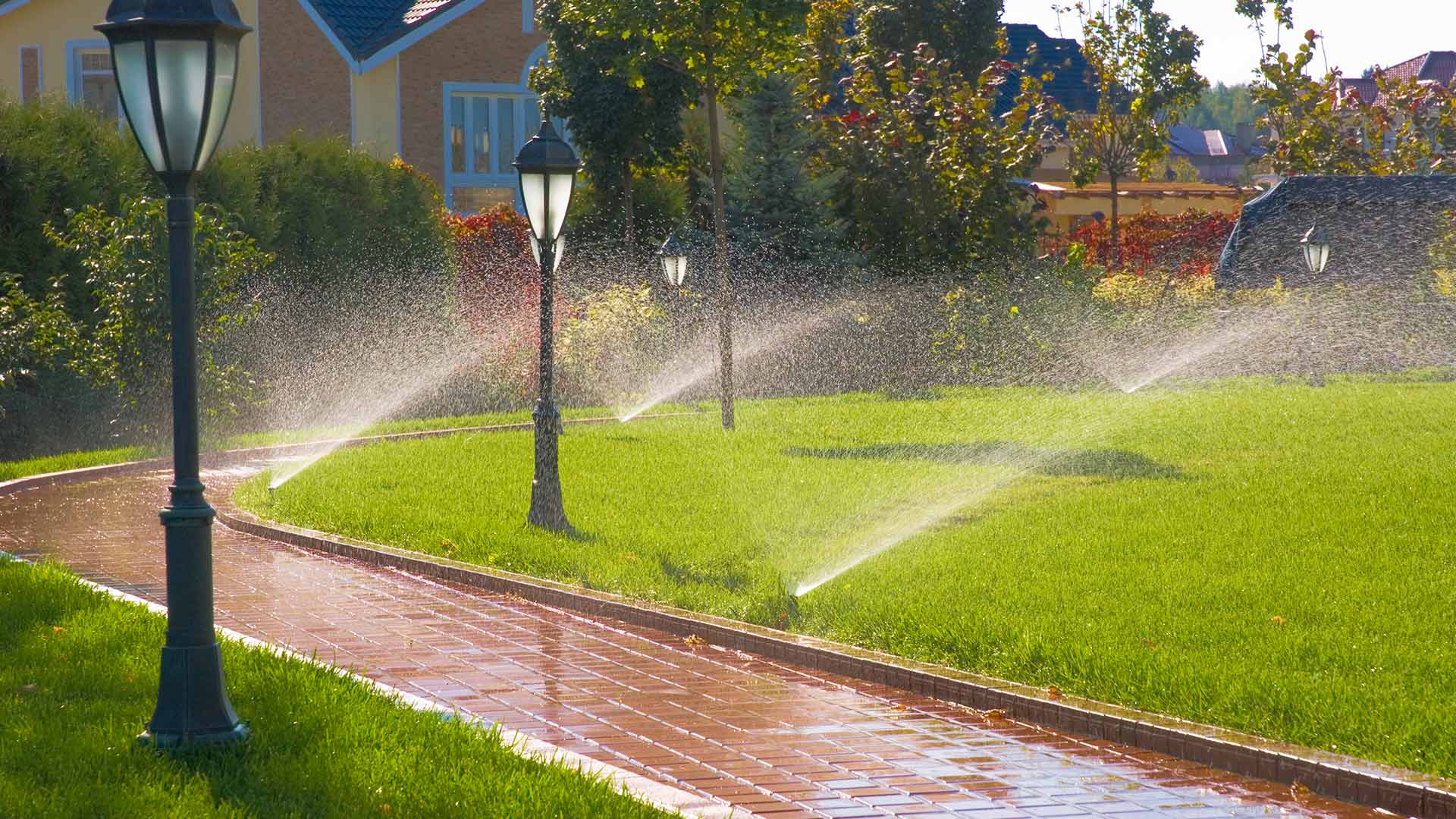 Newly installed sprinkler irrigation system watering a residential lawn in Smyrna, GA.