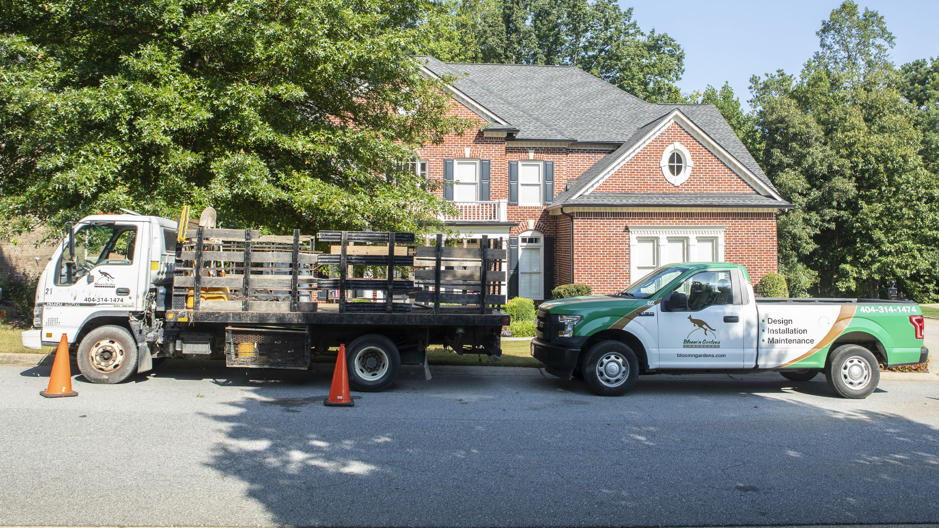Our work truck and trailer parked in front of a clients home.