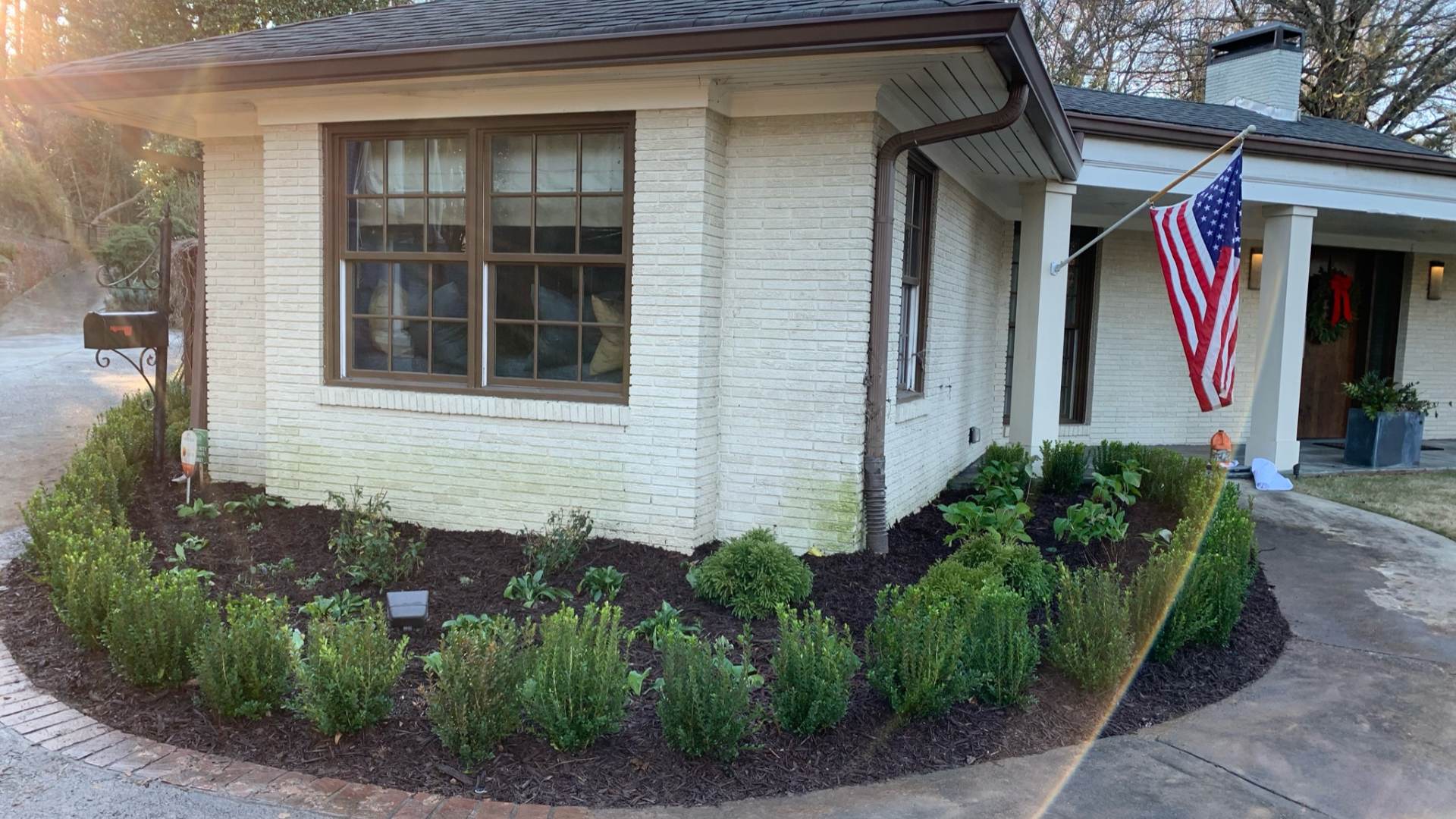 Front landscaping bed with new mulch and plantings in Roswell, GA.