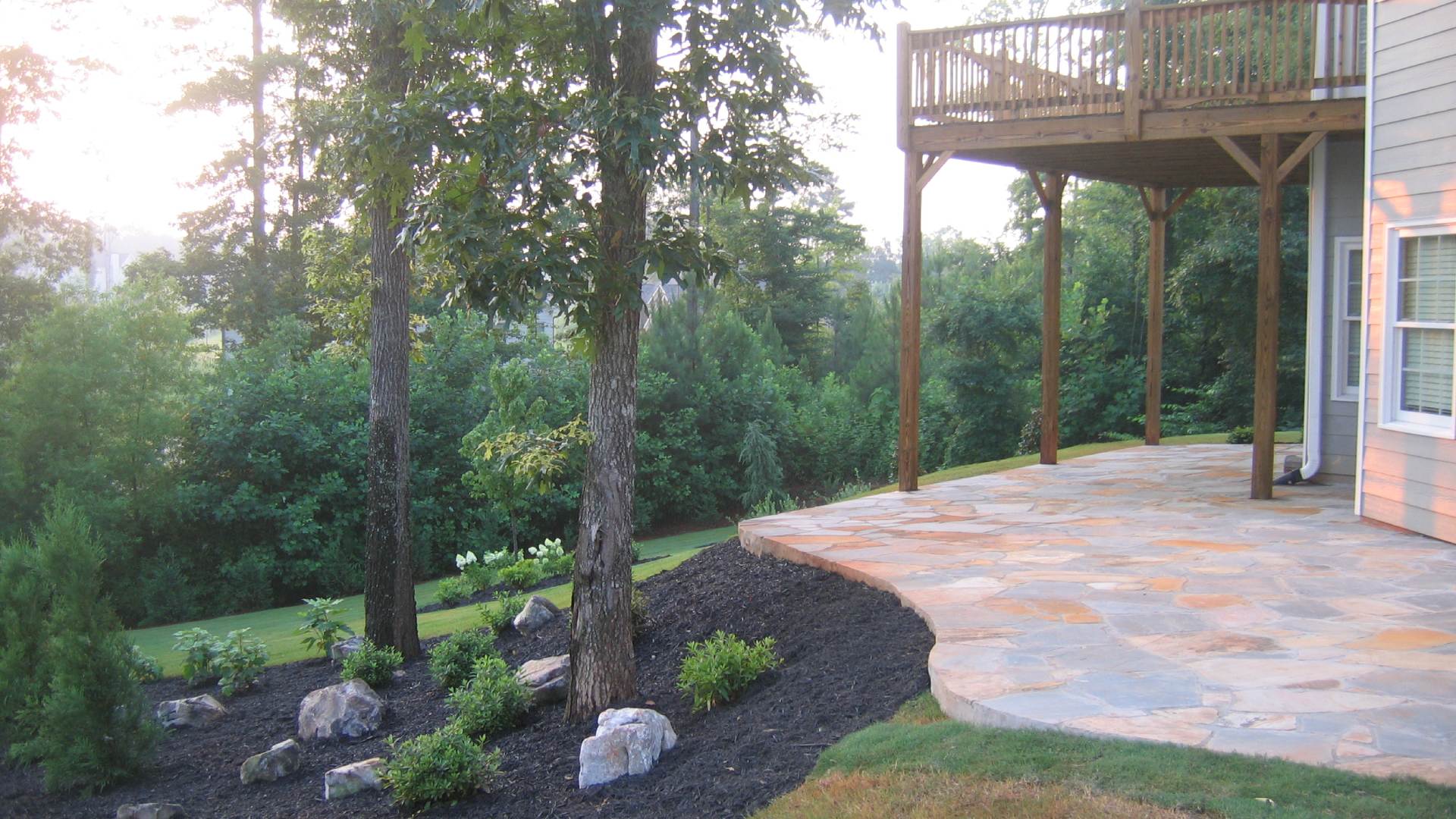 Patio installed beside mulch bed in Peachtree City, GA.