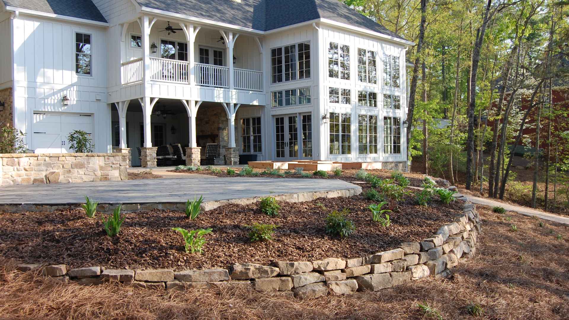 A retaining wall with mulching and plantings installed in Johns Creek, GA.