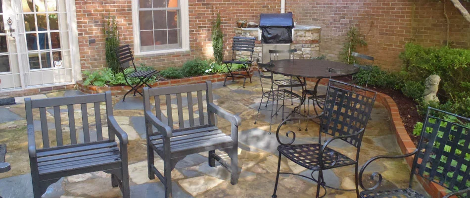 A new flagstone patio installed with a small outdoor kitchen at a residents in Atlanta, GA.