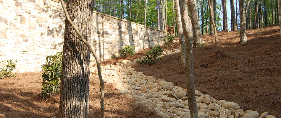 Dry creek bed drainage solution installed down a hill in Atlanta, GA.