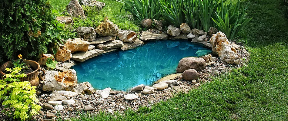 A majestic turquoise-blue pond water feature installed near Atlanta, GA.