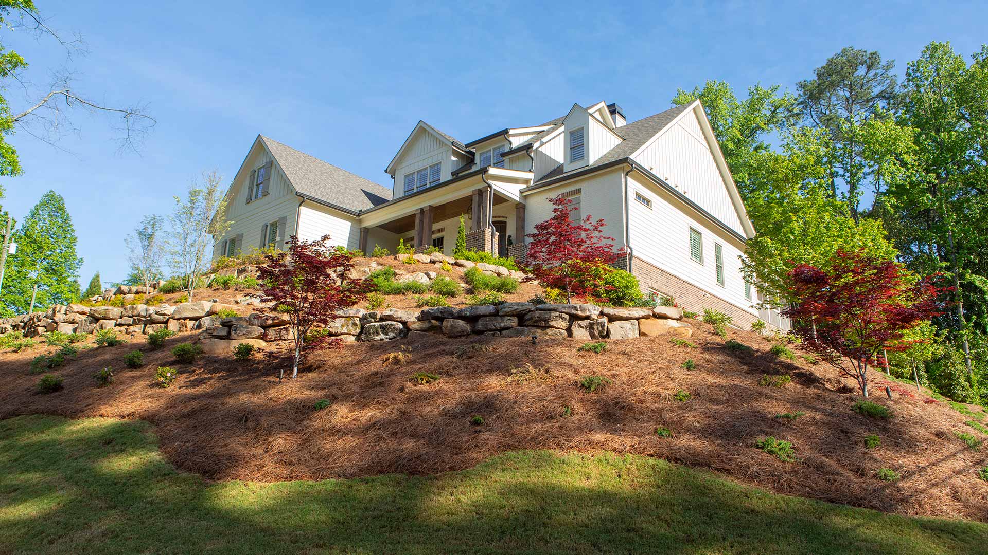 Hillside landscaping with natural stone and water accents in Smyrna, GA.
